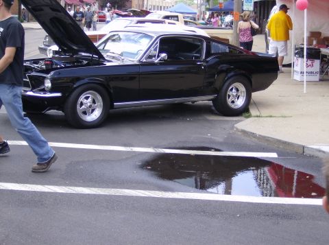 1970 Ford Ranchero - A black 1967 Ford Mustang Fastback is displayed with its hood open at an outdoor car show.