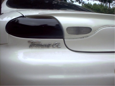 1997 Ford Taurus - Rear view of a white 1997 Ford Taurus GL with tinted taillights.