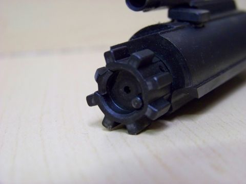 1995 Mercury Grand Marquis - A close-up view of a firearm bolt carrier group, showing its intricate mechanical components.