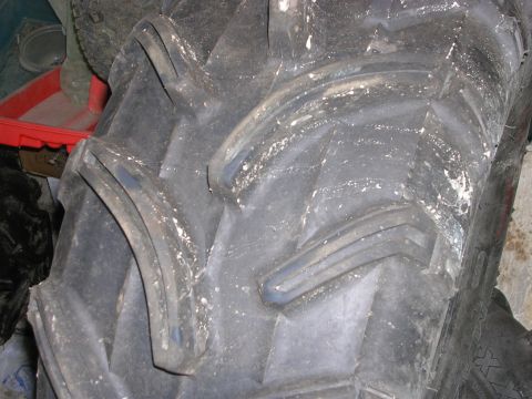 2008 Bombardier Outlander - A close-up view of a tire, likely from an ATV or similar off-road vehicle, shows its aggressive tread pattern.