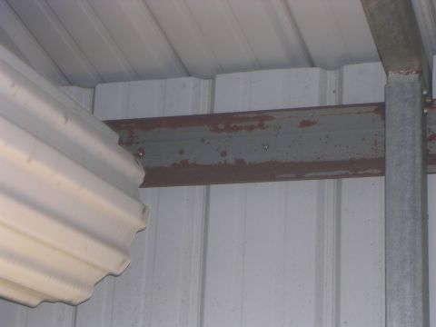 2008 Bombardier Outlander - The interior of a building shows a rusty metal beam supporting the roof structure.