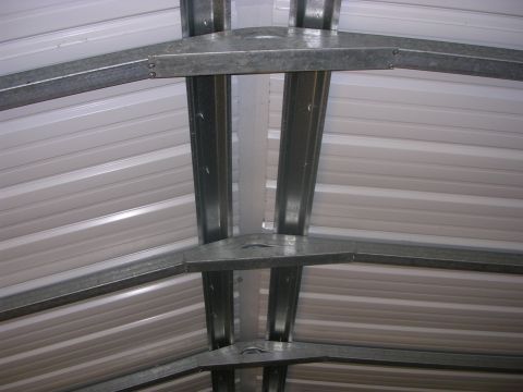2008 Bombardier Outlander - The interior of a metal shed shows the corrugated roofing and supporting steel beams.