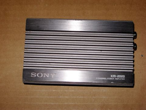 1975 Ford Torino - Sony XM-2020 2-channel power amplifier shown on a brown surface.