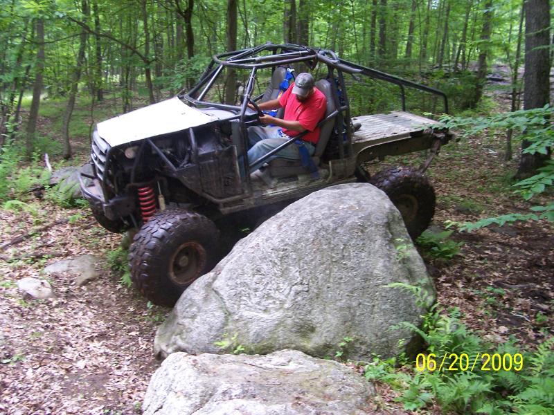 Off-road buggy with roll cage navigating rocks