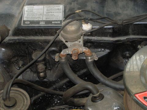 1970 Ford Ranchero - Close-up of a heater control valve assembly with hoses connected.