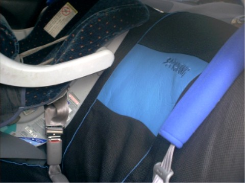 1997 Ford Taurus - Interior view of a car showing a child seat and seatbelt.