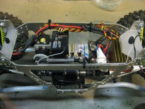 2010 Ford Pickup - The internal components of an RC car chassis are shown, including the battery and electronic speed controller.