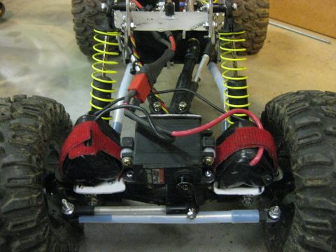 2010 Ford Pickup - Close-up view of the front suspension system of a remote control car, showing its components and wiring.