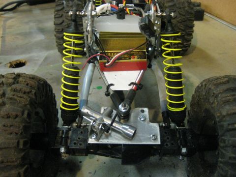 2010 Ford Pickup - Close-up view of the suspension system on a remote control vehicle, bright yellow springs and a gold electronic control unit.