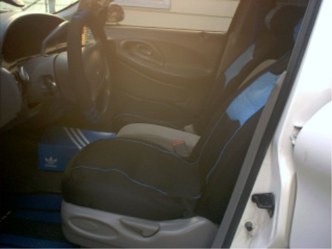 1997 Ford Taurus - Interior view of a car showing seats, dashboard, and a shoe box on the floor.