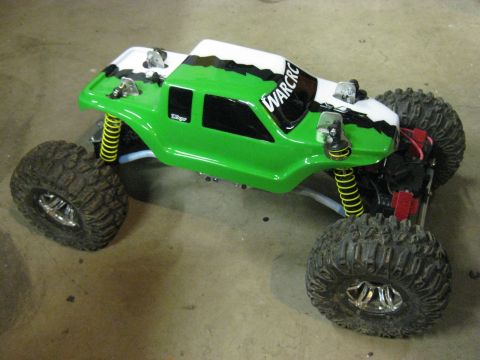 2010 Ford Pickup - This remote control rock crawler features a vibrant green and white paint scheme with "WARCRC" visible on the windshield.