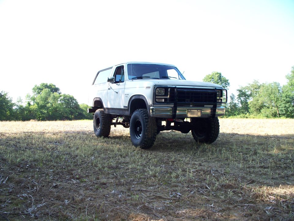 White lifted SUV with bull bar, front view. Appears to be from the early 1980s