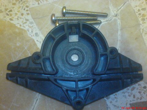 1992 Ford Crown Victoria - A disassembled window regulator bracket and screws are shown on a tiled surface.
