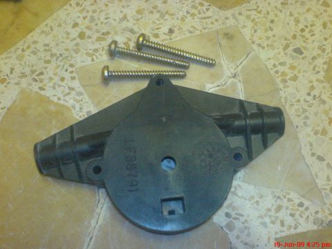 1992 Ford Crown Victoria - A disassembled window motor part and screws are shown on a tiled surface.