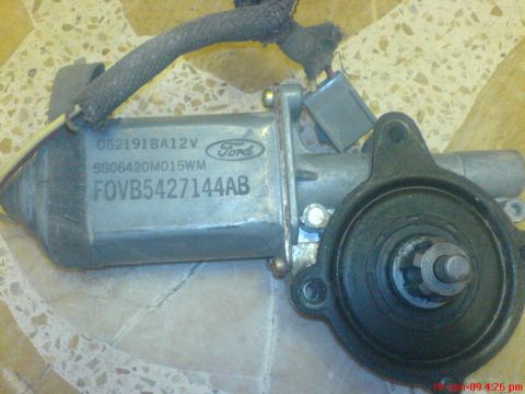 1992 Ford Crown Victoria - A disassembled Ford window motor is shown, with visible part numbers and the Ford logo.
