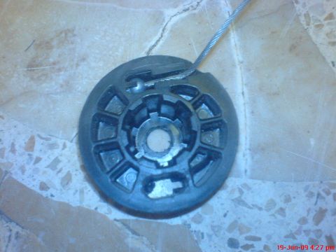 1992 Ford Crown Victoria - This is a disassembled part of a car's window mechanism, showing the internal gears and a cable.