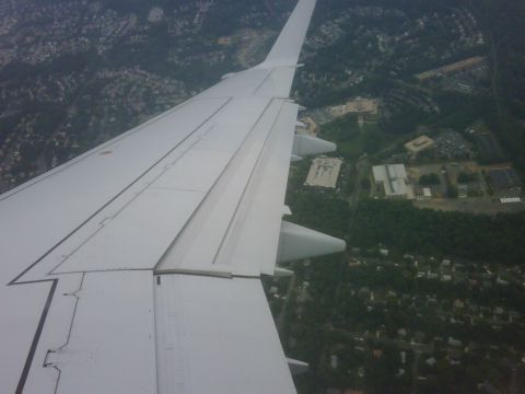 1996 Ford Bronco - Aerial view of a suburban landscape seen from an airplane, with the aircraft's wing prominently in the foreground.