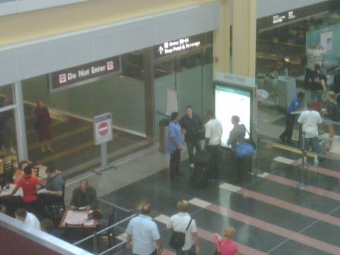 1996 Ford Bronco - Interior view of an airport terminal with various signs and people.