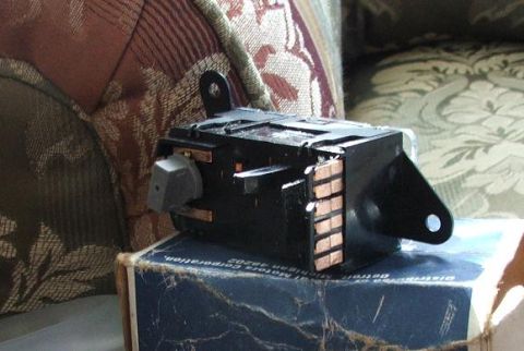 1991 Ford Crown Victoria LTD - Automotive electrical part with copper contacts shown on a box.