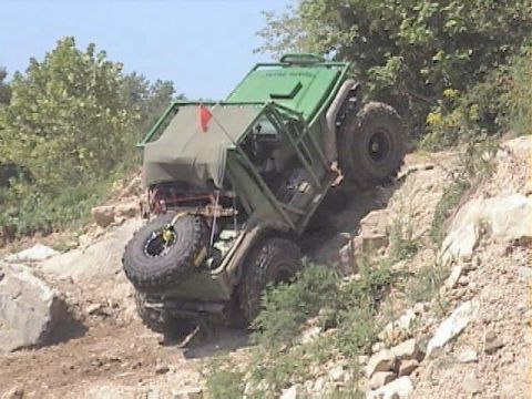 1992 Ford Bronco - Off-road vehicle navigates a challenging rocky terrain on an incline.