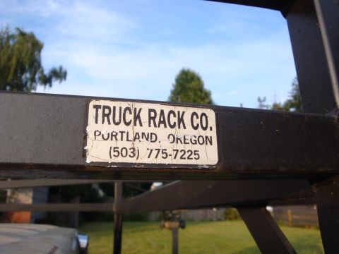 1988 Ford F-350 - Sticker on a truck rack shows company name and contact information.