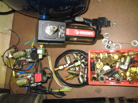 1996 Chevrolet Cavalier - Close-up of air suspension components, including a Husky solenoid valve and various pneumatic fittings.