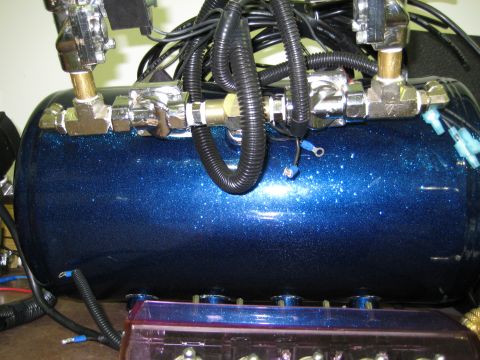 1996 Chevrolet Cavalier - Close-up of a custom blue air suspension tank with various fittings and wiring.