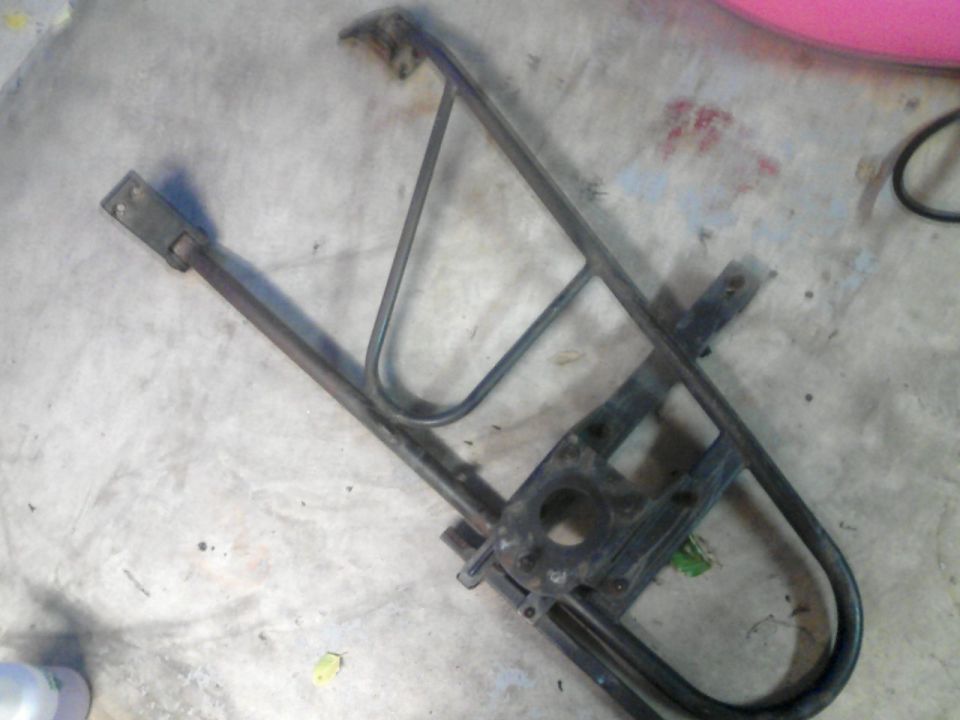 metal window regulator mechanism on concrete floor