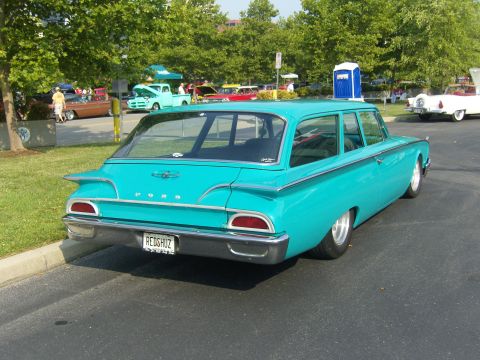 2007 Ford Mustang - A classic turquoise Ford station wagon is parked at an outdoor event with other vehicles in the background.