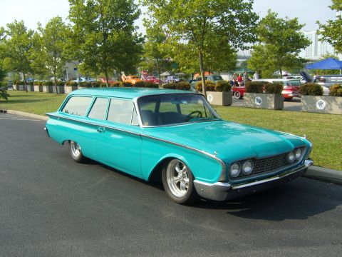 2007 Ford Mustang - A vintage turquoise station wagon is parked on asphalt, with trees and other vehicles in the background.