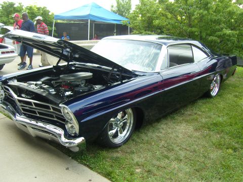 2007 Ford Mustang - Custom 1966 Ford Galaxie on display at a car show, a V8 engine under the open hood.