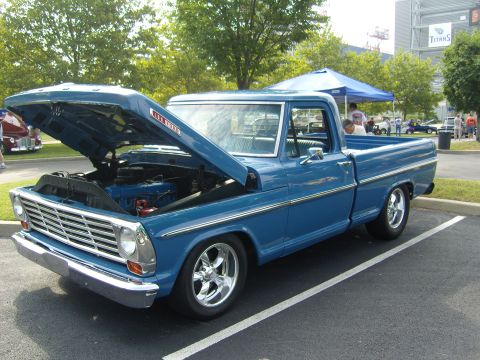 2007 Ford Mustang - This blue 1967 Ford F-100 pickup truck is displayed with its hood open, revealing the engine.