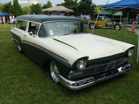 2007 Ford Mustang - A classic two-tone station wagon is displayed at an outdoor event with other vehicles and tents in the background.