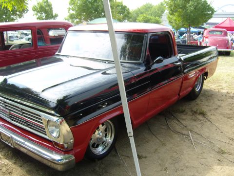 2007 Ford Mustang - A two-tone 1967 Ford F-Series pickup truck is displayed at an outdoor event.