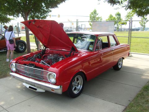2007 Ford Mustang - Classic red car on display, hood raised to reveal the engine compartment.
