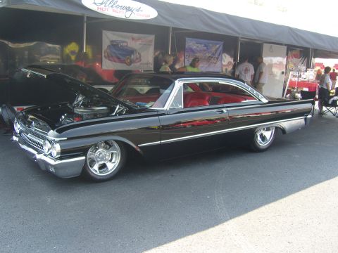 2007 Ford Mustang - A classic black 1960 Ford Starliner is displayed with its hood up at an outdoor event.