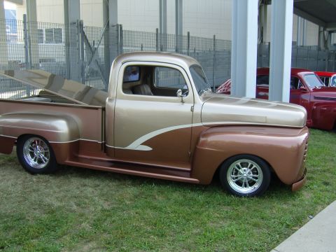 2007 Ford Mustang - This custom pickup truck features a two-tone paint scheme with brown and tan colors, accented by flame graphics on the front fender.