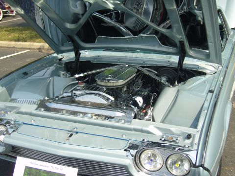 2007 Ford Mustang - Close-up of the engine bay in a 1961 Ford Thunderbird, a polished V8 engine.