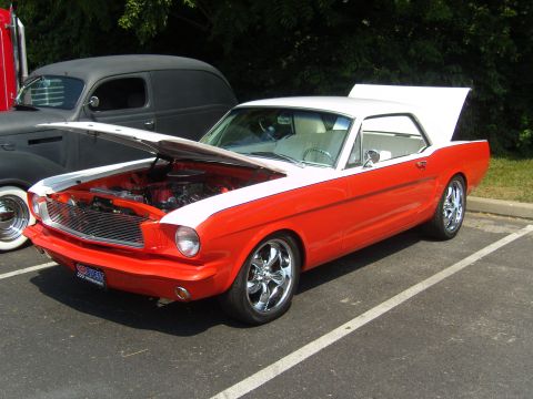 2007 Ford Mustang - A classic two-tone 1965 Ford Mustang is displayed with its engine and trunk exposed, parked outdoors.