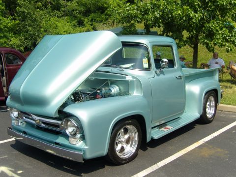 2007 Ford Mustang - A classic light blue 1956 Ford F-100 pickup truck is displayed with its hood open, revealing the engine bay.