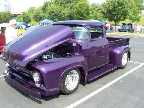 2007 Ford Mustang - Customized purple 1956 Ford F-series pickup truck displayed with its hood open at a car show.