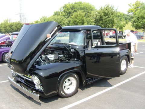 2007 Ford Mustang - Customized black 1950s Ford F-series pickup truck displayed at a car show.