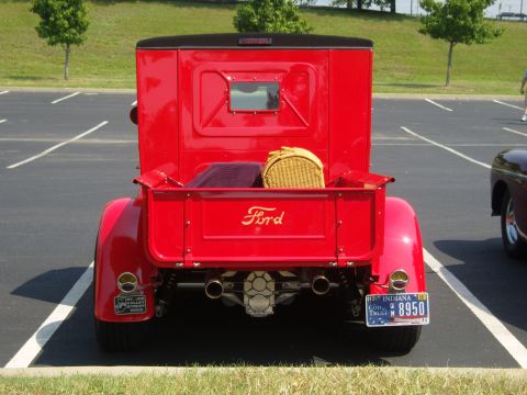 2007 Ford Mustang - Red Ford pickup truck parked in a lot with another vehicle visible to the right.