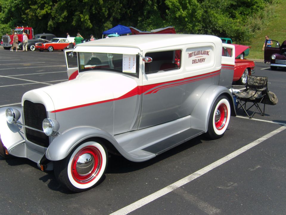 Two-tone silver and white delivery van with red pinstripes and red wheels
