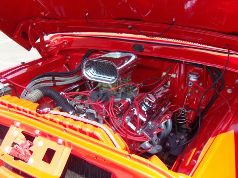 2007 Ford Mustang - Close-up of a V8 engine bay, chrome components and red wiring.