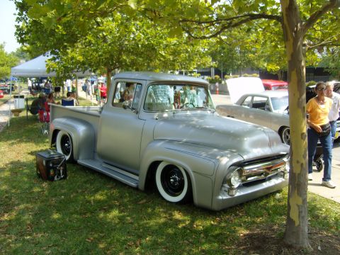 2007 Ford Mustang - A custom 1956 Ford F-100 pickup truck is displayed at an outdoor car show.