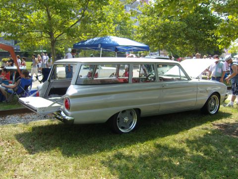 2007 Ford Mustang - Silver 1963 Ford Falcon station wagon displayed at an outdoor event with people around.