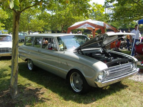 2007 Ford Mustang - A vintage Ford Falcon station wagon is displayed with its hood open at a car show.