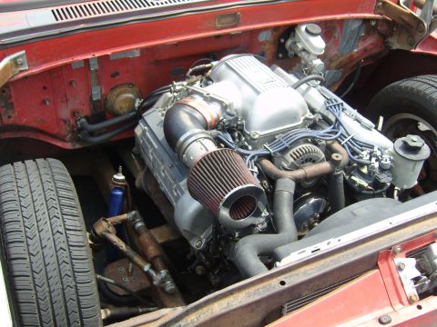 2007 Ford Mustang - Close-up view of a V8 engine installed in a vehicle's engine bay, an aftermarket air intake system.