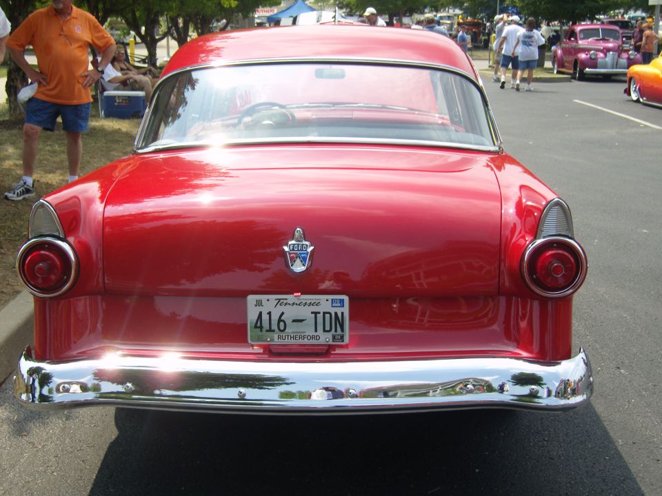 Red classic car rear view, chrome bumper, round taillights, Tennessee license plate 416-TDN